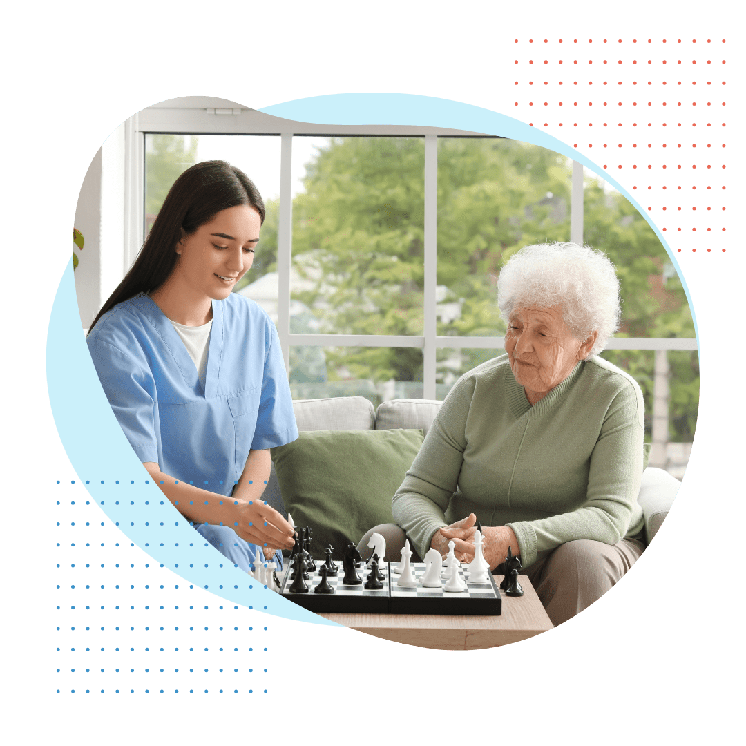 caregiver playing chess with elderly woman