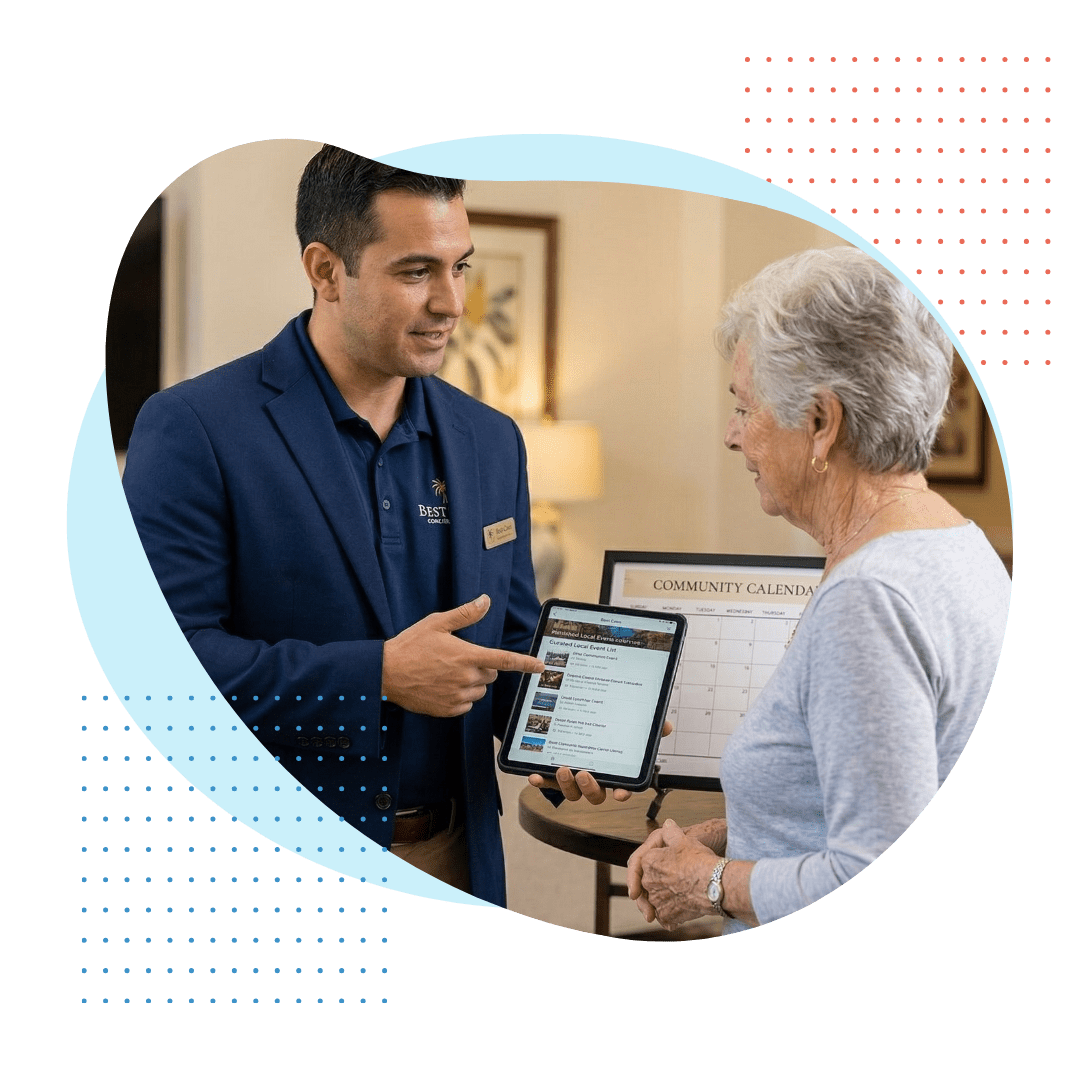 a male Best Care staff member acts as a concierge, helping an elegant elderly woman in a cozy Vizcaya-style community lounge, displaying a curated event calendar.