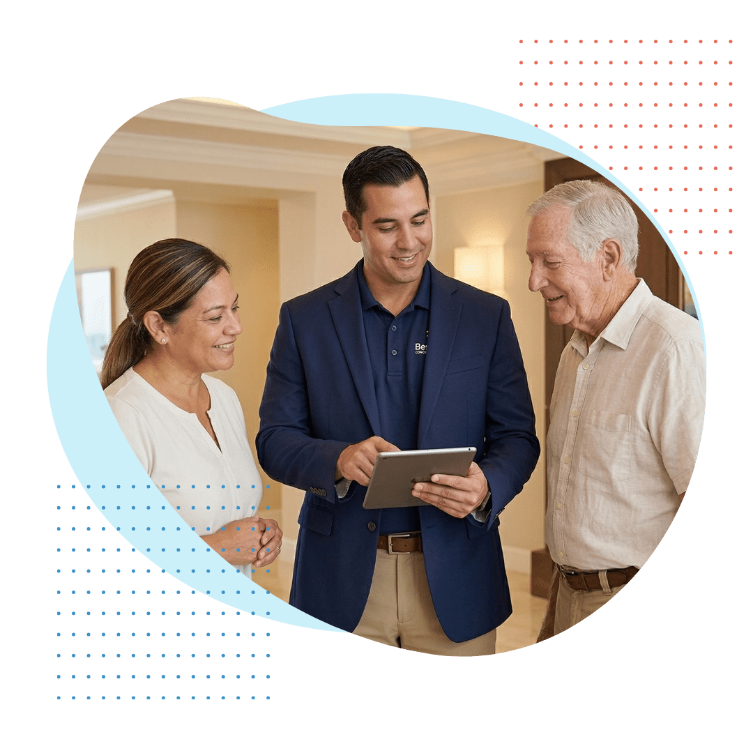A professional and knowledgeable male Best Care concierge care specialist, wearing a polished navy blazer over a polo shirt (branded), is presenting a customized wellness and activity plan on a tablet to a senior couple. The environment is warm and prestigious.