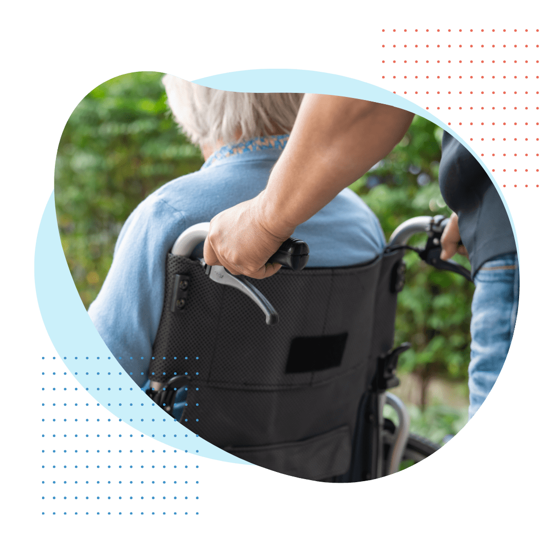 man pushing woman in wheelchair